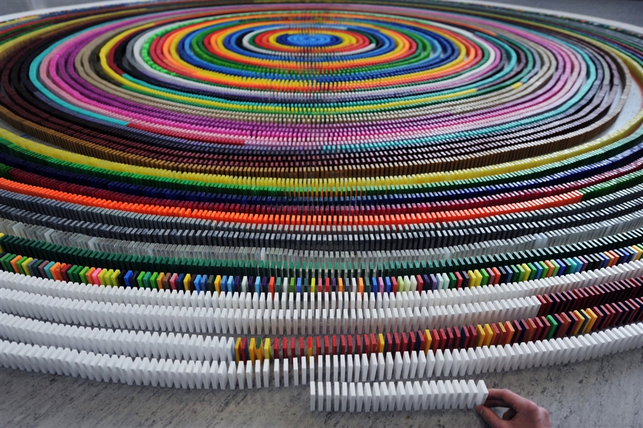 Trying to break record for longest spiral of dominoes